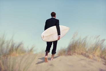 businessmen with surfboards, signs of bleisure impacting travel management companies